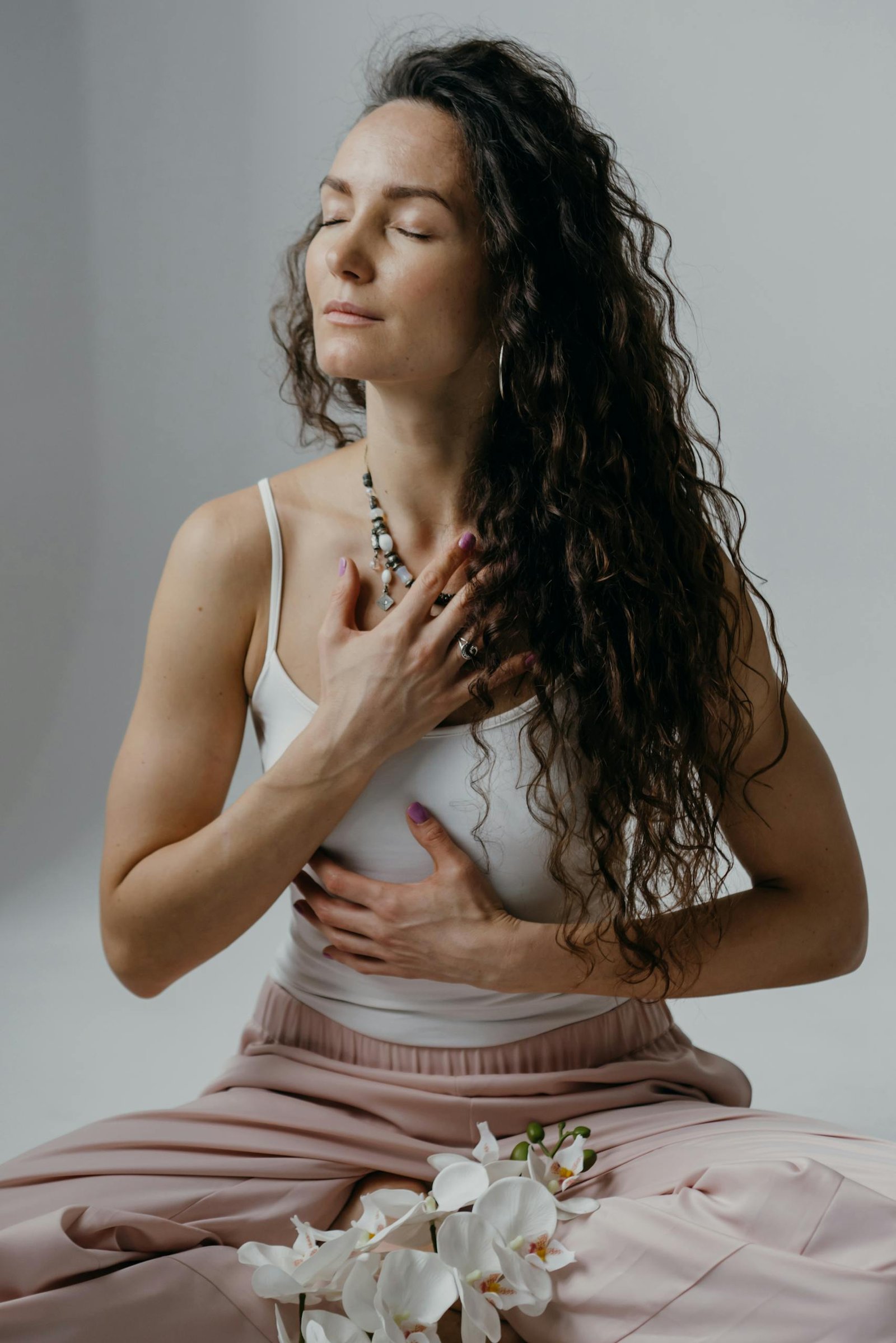 Portrait of a serene woman meditating with eyes closed, capturing relaxation and mindfulness.